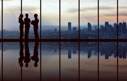 Businesspeople in front of urban cityscape.